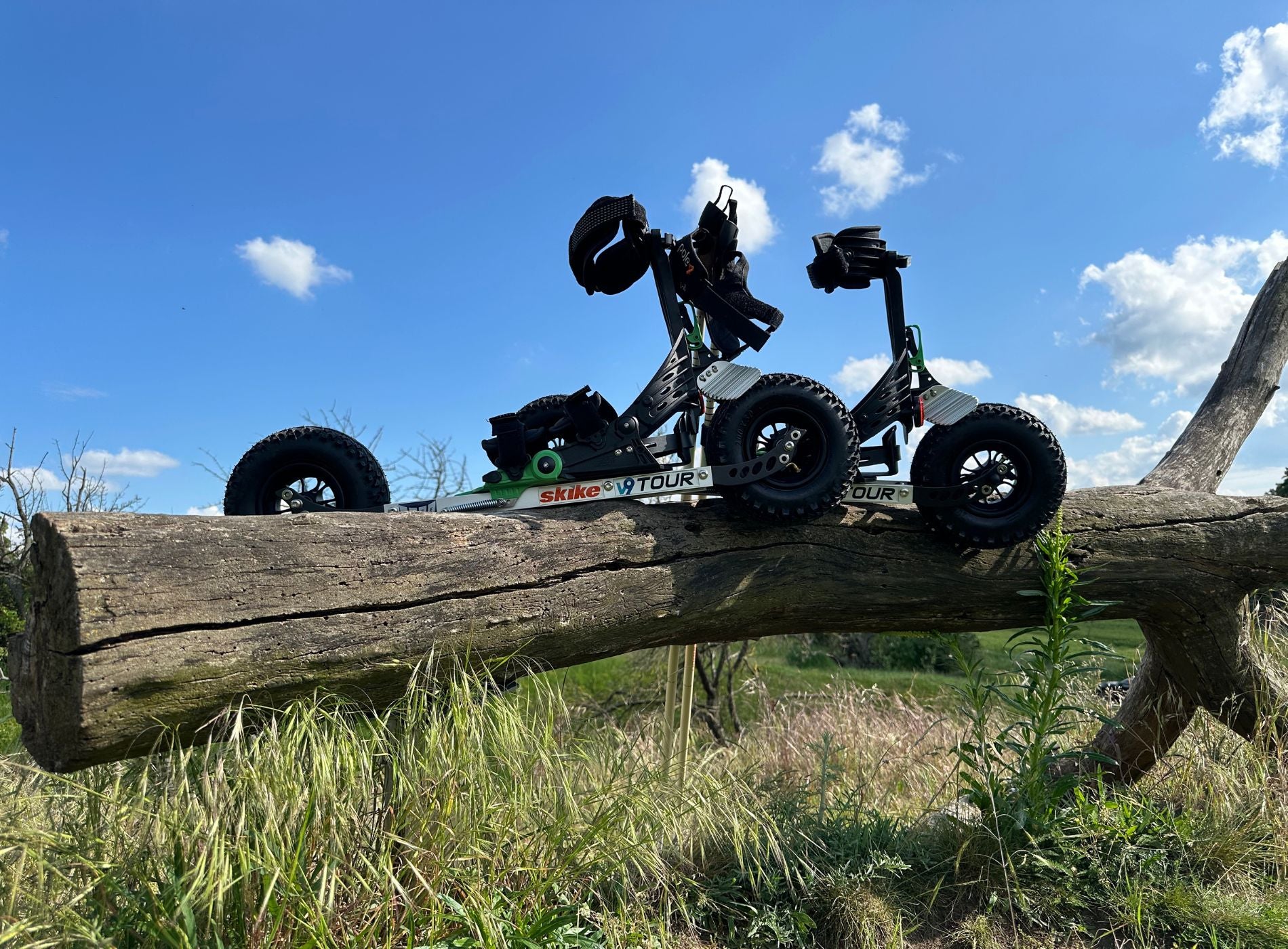 skike v9 TOUR 200 Cross Skate propped alongside 2 poles on a fallen tree